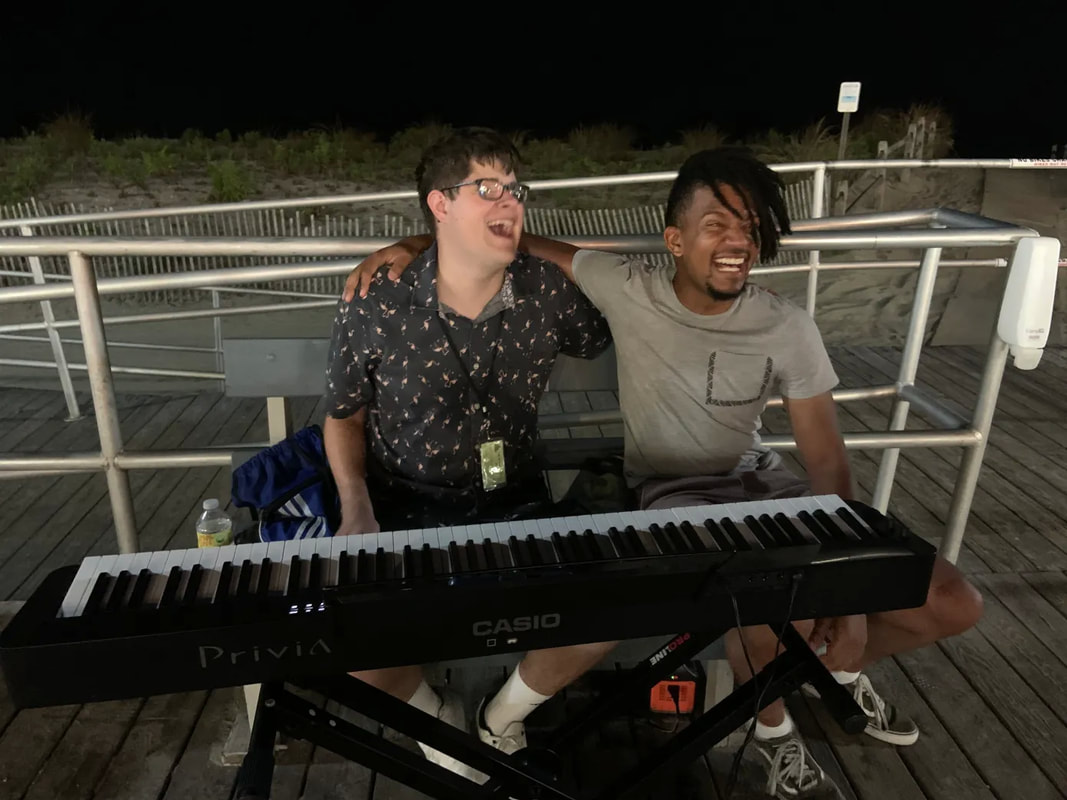 Image of Bryan Woolbert and Isaiah Showell behind keyboard on Ocean City NJ Boardwalk, Follow South Jersey, Link Graphic